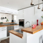 White kitchen design with breakfast bar and storage