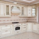 Design of a white kitchen in the interior with a corner set