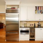 Refrigerator in the white kitchen corner interior.