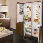 The refrigerator in the interior of the kitchen is two-section built-in