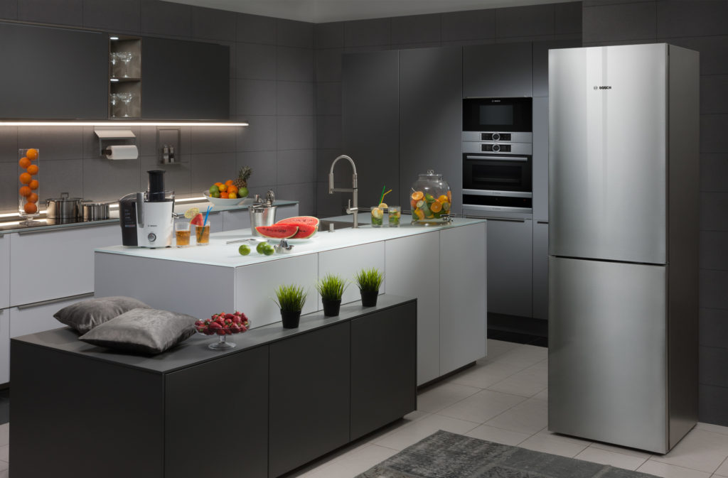 Refrigerator in the interior of the kitchen in gray tones