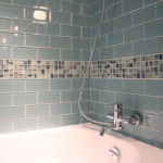 Mosaic in the bathroom corbel between the rows of ceramic tiles