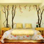 Wall decoration in the bedroom with a pattern and photographs