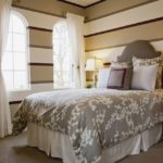 The decoration of the walls in the bedroom with striped paint