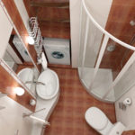 Design of a bathroom in Khrushchev with a narrow sink and shower
