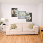 Asymmetric triptych paintings in the living room interior