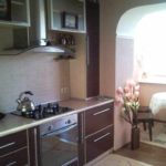 An example of a bright decor of a kitchen in a living room 16 sq. m. photo
