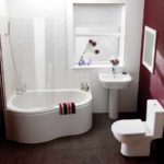 option of a light bathroom interior with a corner bathtub photo