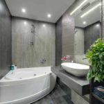 An example of a beautiful bathroom design with a corner bathtub photo