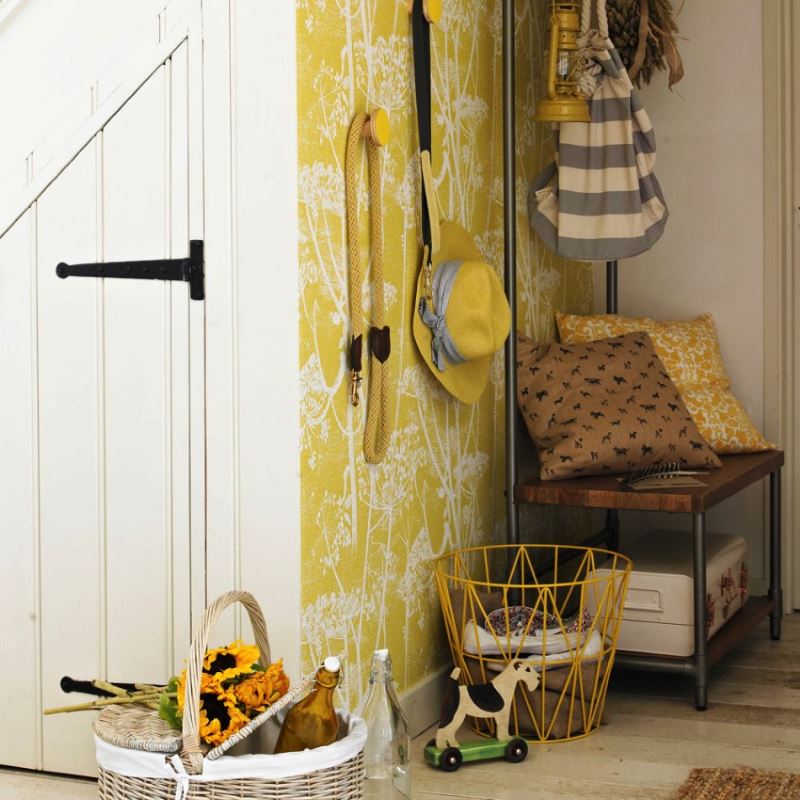 Vinyl wallpaper with a yellow background on the wall of the hallway