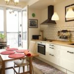 Kitchen with a door to a balcony in a panel house