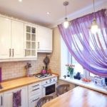 Purple curtains in the interior of the kitchen