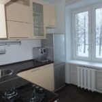 Mutfak penceresinin yanında gümüş buzdolabı