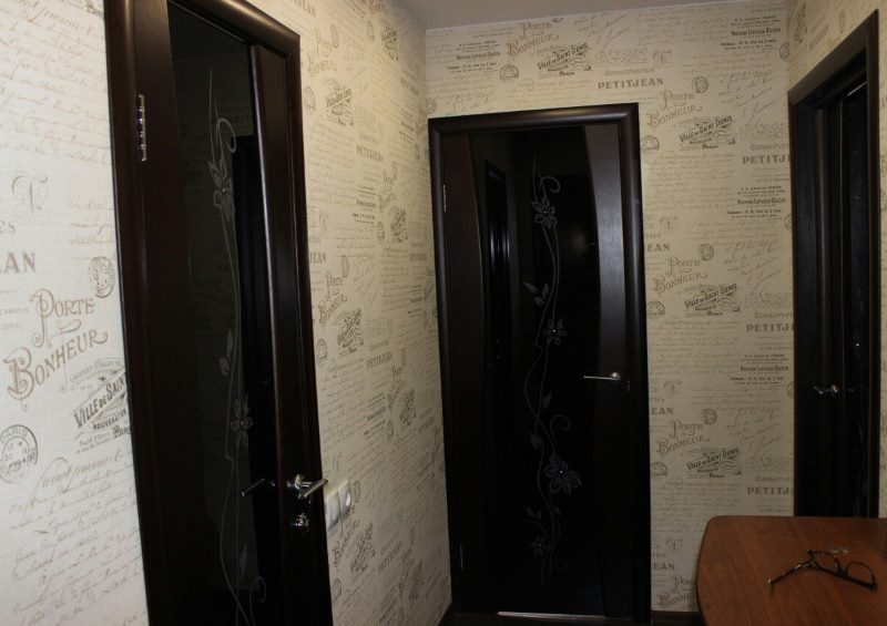 Black doors in a small hallway