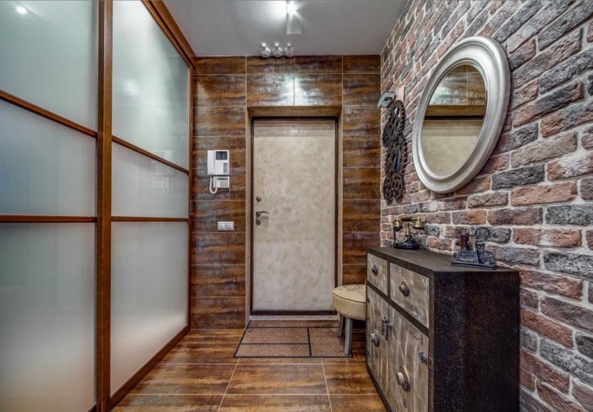 Sliding wardrobe with glass doors in the hallway interior