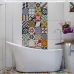 Unusual mosaic among white tiles in the bathroom