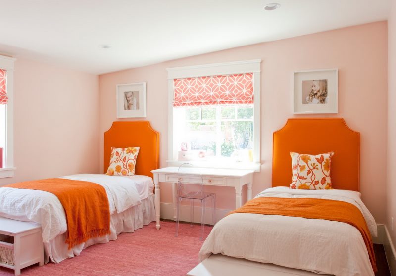 Orange color in the interior of the nursery for two girls