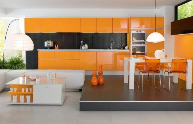 Cozinha laranja brilhante com área de jantar