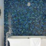 Multi-colored curly tiles for the decor of one bathroom wall