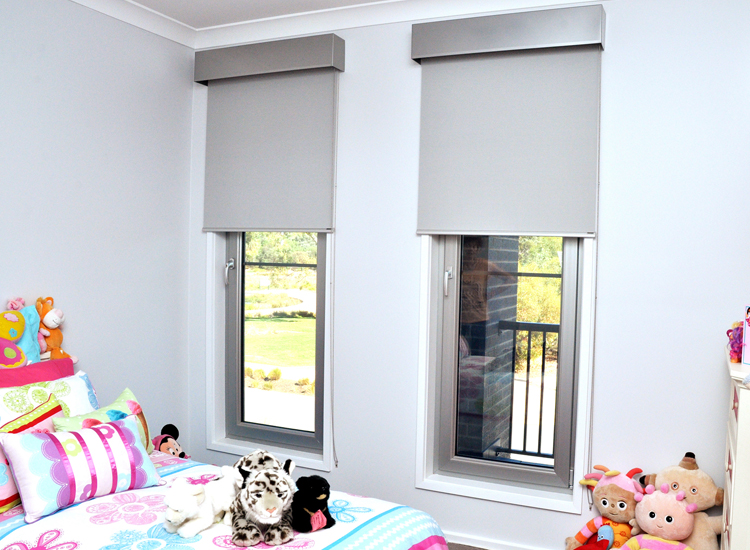 Windows in a private nursery with roller blinds