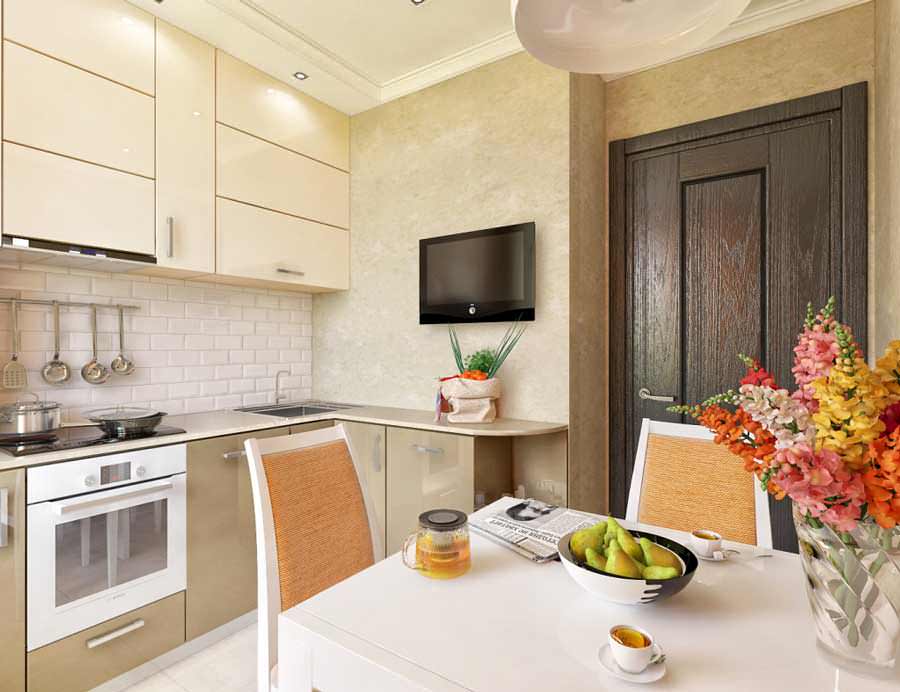 Cream colored kitchen with cupboards to the ceiling