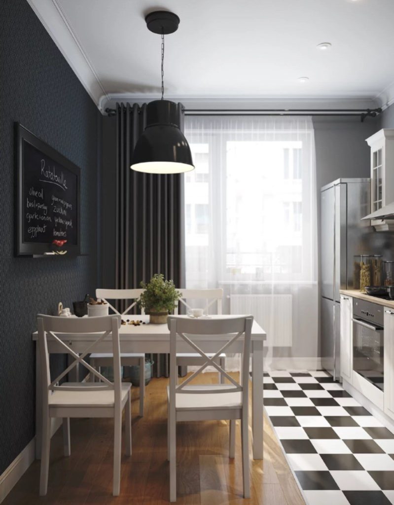 Mesa de jantar brilhante em frente a uma parede preta em uma cozinha de 8 quadrados