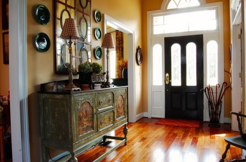 Design a spacious hallway of a private house with a chest of drawers in retro style