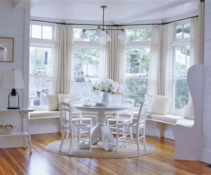 White furniture in the kitchen bay window of a country house