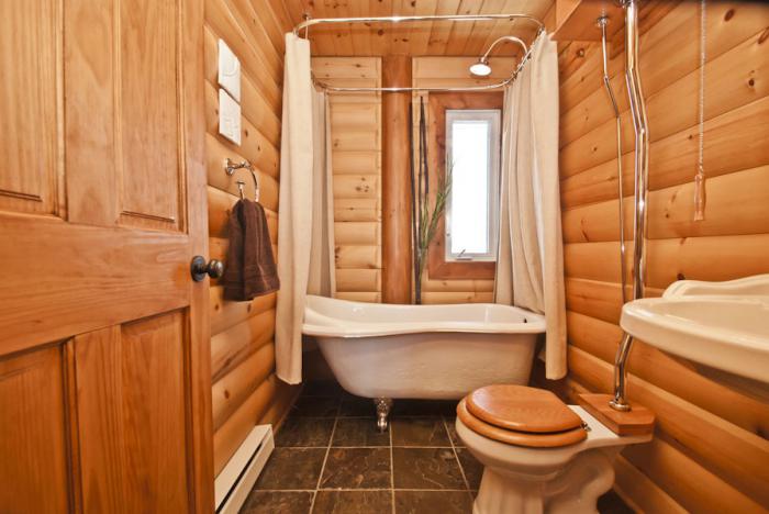 Interior of a narrow bathroom in a wooden house