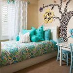 Turquoise pillows on a colorful bedspread