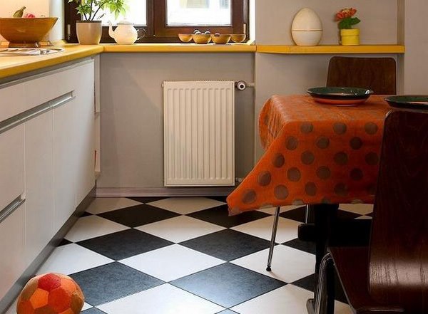 Black and white tiles on the floor of a small kitchen