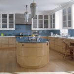 Multifunctional kitchen island with glossy facades