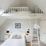 White bedroom in the attic of a country house