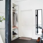 Open wardrobe in the hallway with white walls