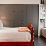 Wooden bed in the bedroom of a private house