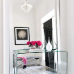 Glass table in front of a large floor mirror