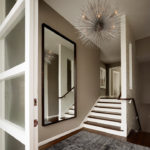 Large mirror in the hallway with stairs
