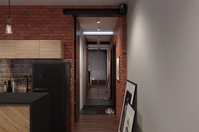 Brick walls in the narrow corridor of the apartment