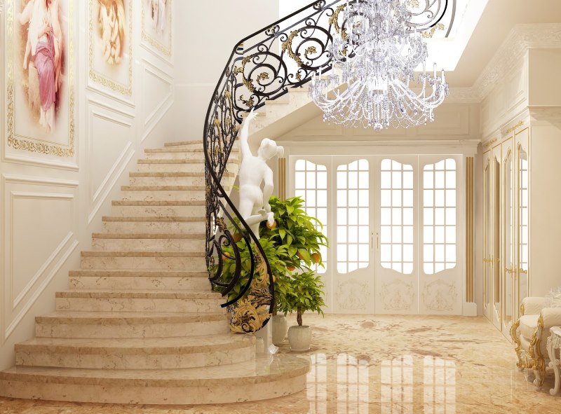 Escalera con baranda de hierro forjado en el vestíbulo de una casa privada.