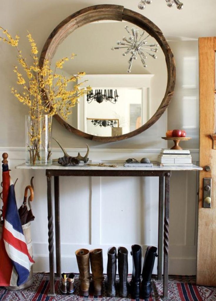 Blooming twigs in a vase in front of a mirror