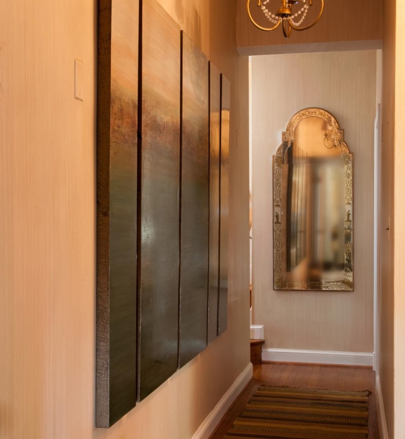 Mirror with a matte finish at the end of a narrow corridor