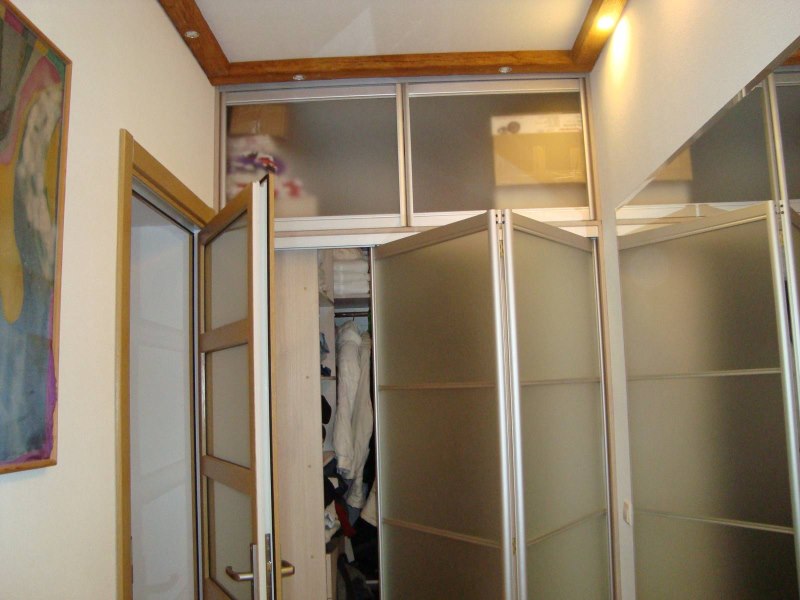Wardrobe with folding doors in the hallway of a city apartment