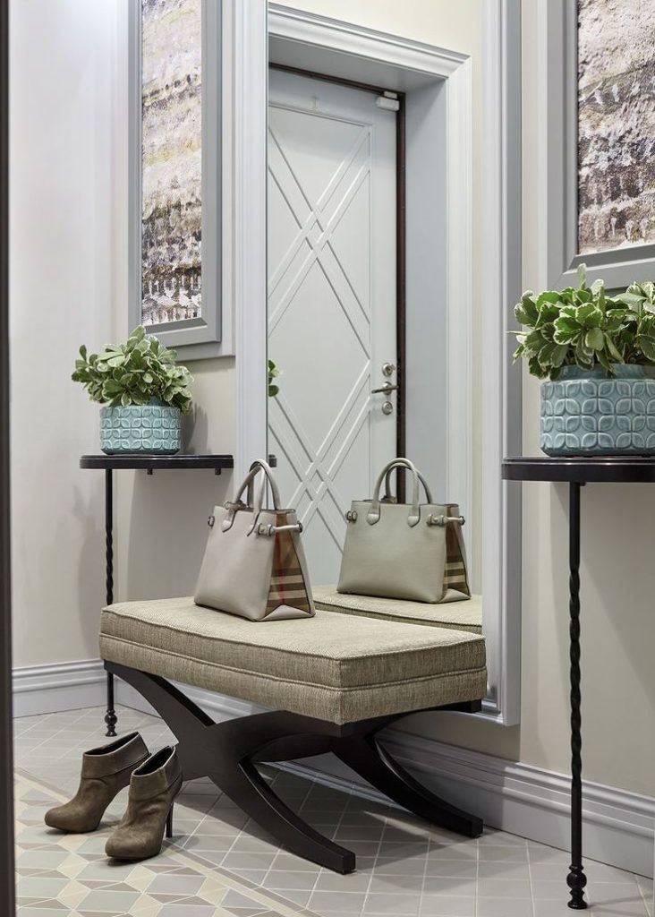 Narrow mirror to the floor in the hallway of a city apartment