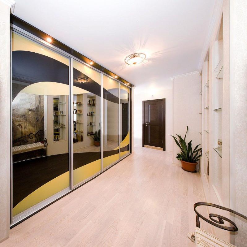 Large closet with mirrored doors in a bright hallway