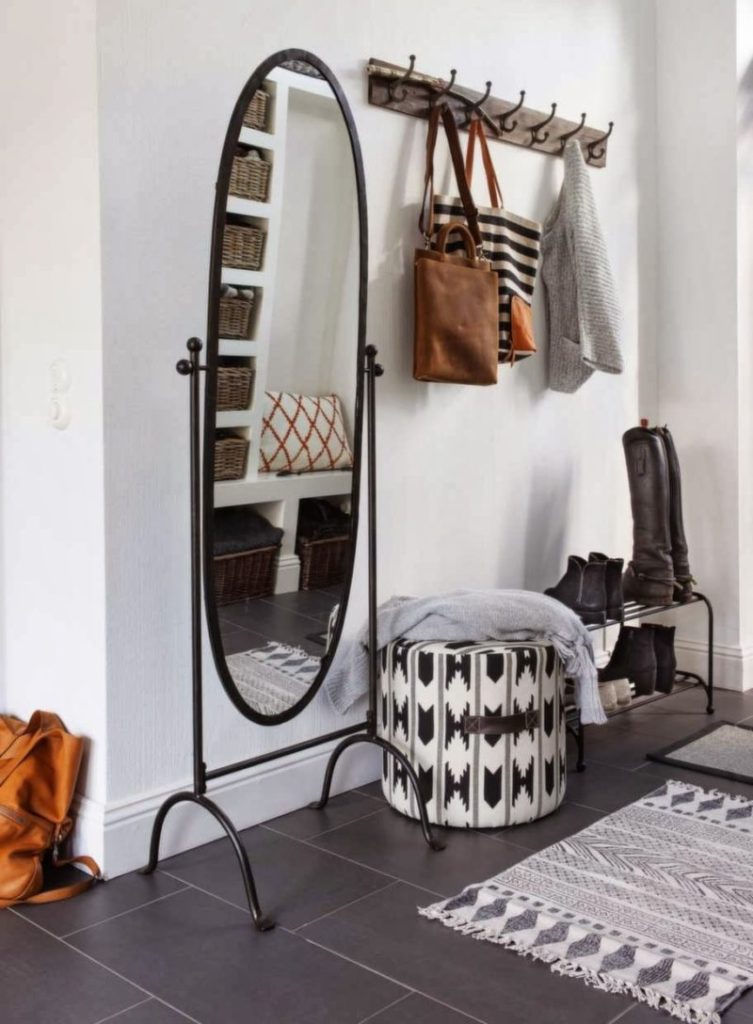 Mirror on a forged stand in the hallway of a rural house