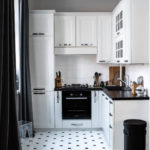 Black curtains in a white kitchen
