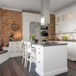 Brick wall in a white kitchen