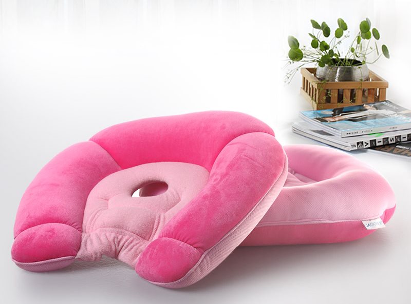 Orthopedic pillow for pregnant women in a pink cover