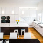 Wooden floor in a white modern kitchen