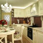 White chandelier on the ceiling of a provence kitchen